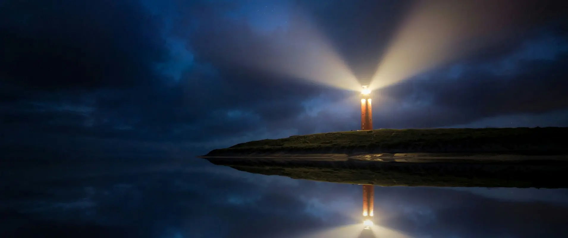 Dramatic cloudy sky reflected in water with rays of light shining, overlaid with images of Rider Waite tarot cards, crystal points, and a crystal pendulum.