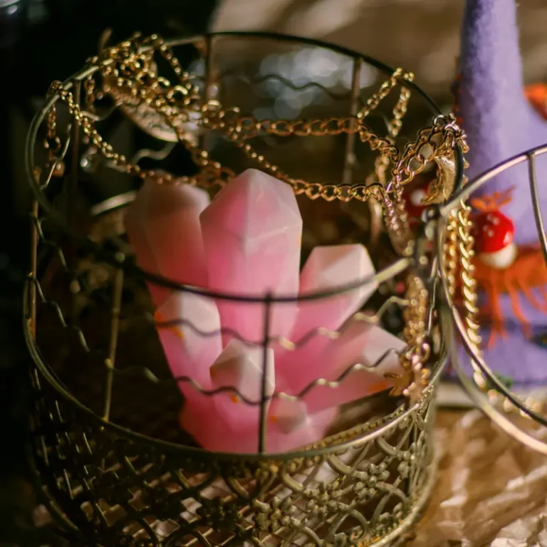 Ornamental crystal cluster inside a gold cage and delicate gold chains.