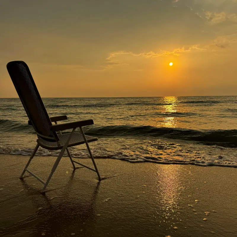 A beach chair and a beautiful sunset.