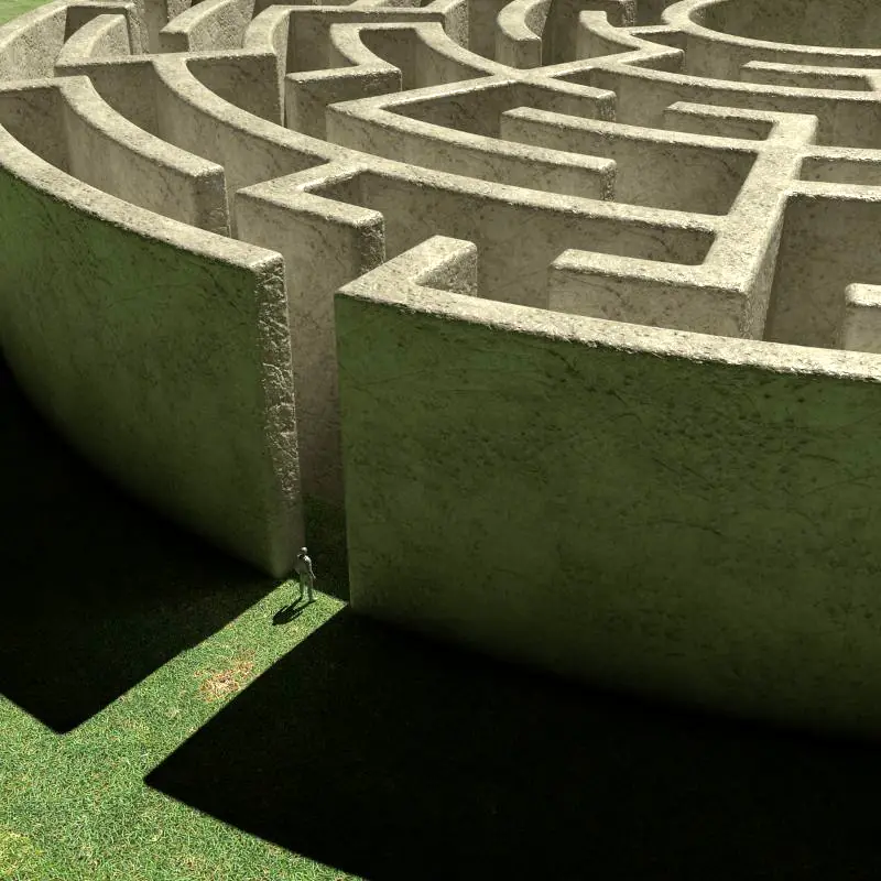 A person stands at the entrance of an enormous maze. Rumination can quickly turn our self reflection into a confusing labyrinth of looping thoughts.