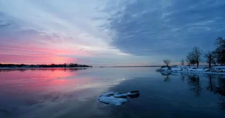Colourful sky reflecting in water, symbolic of how our own perception and perspective can influence our self-reflection